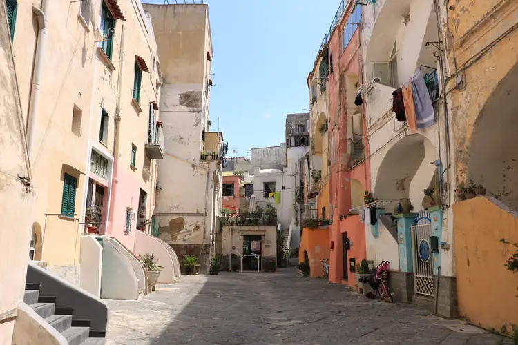 Una strada stretta con colorati edifici casale sullo sfondo.